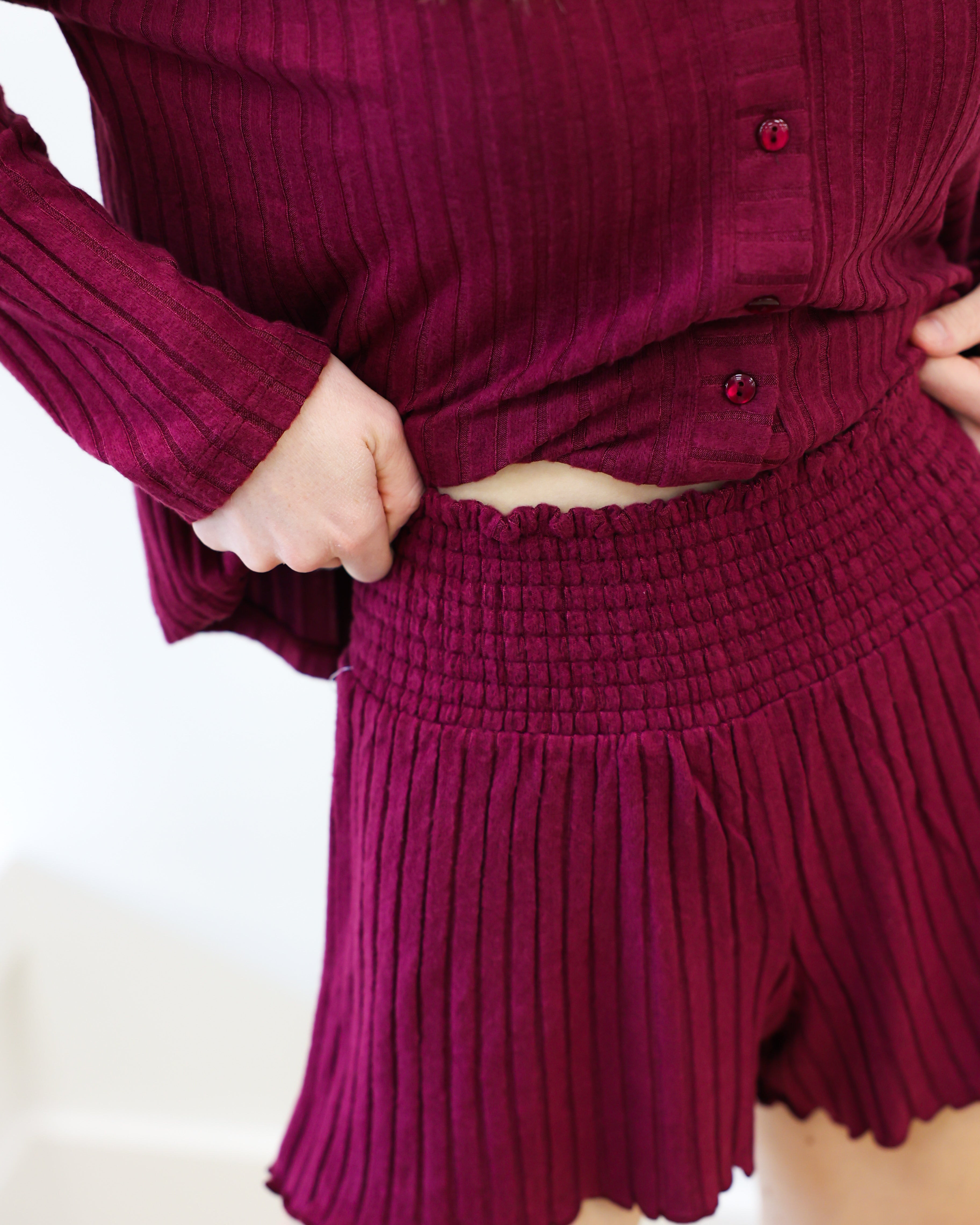 Maroon ribbed outfit with a top and shorts on a white background