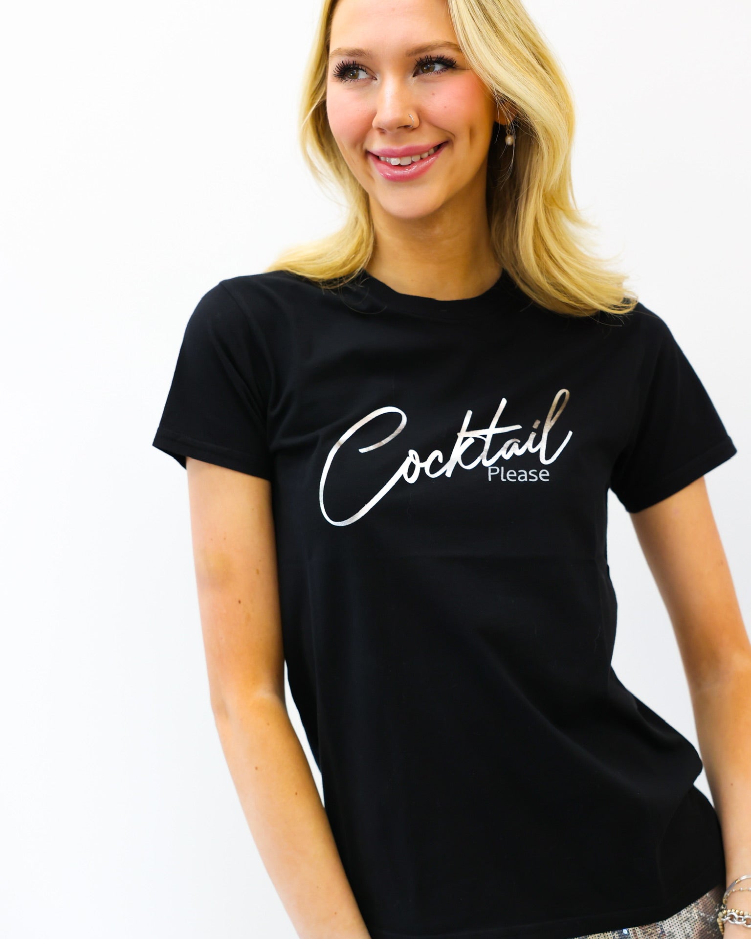 Woman wearing a black t-shirt with 'Cocktail Please' text on a white background