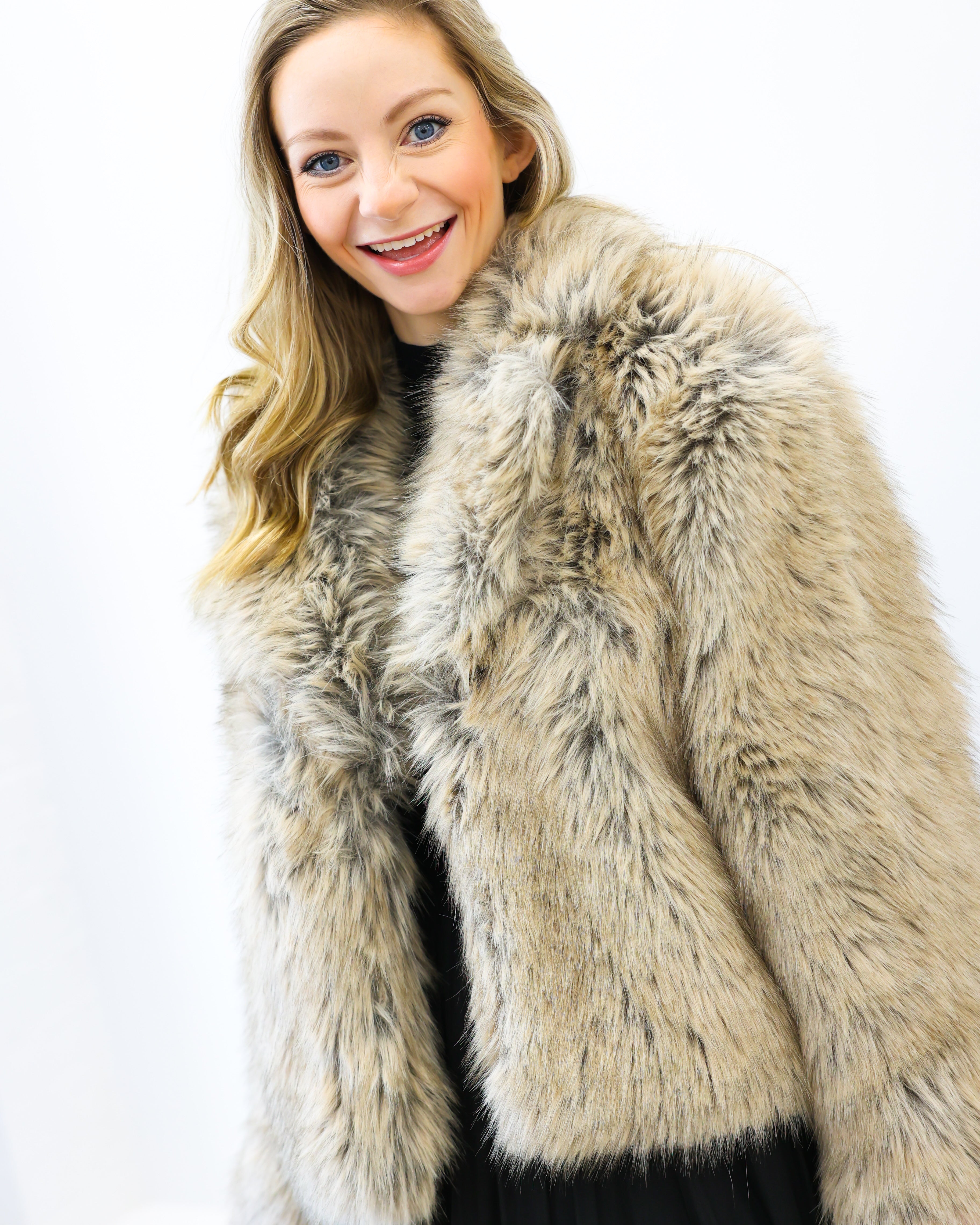 Woman wearing a fur coat against a white background