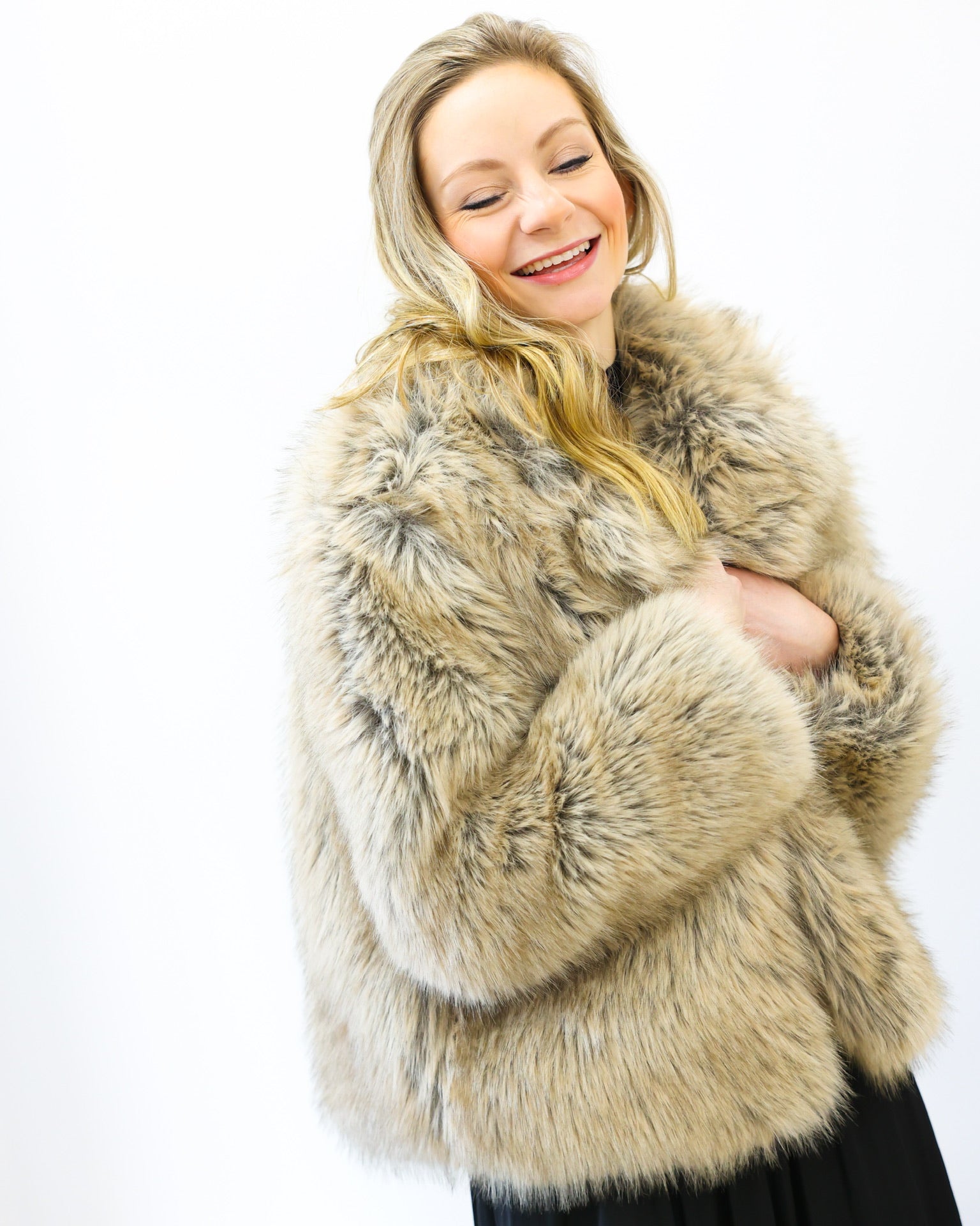 Woman wearing a fur coat on a white background