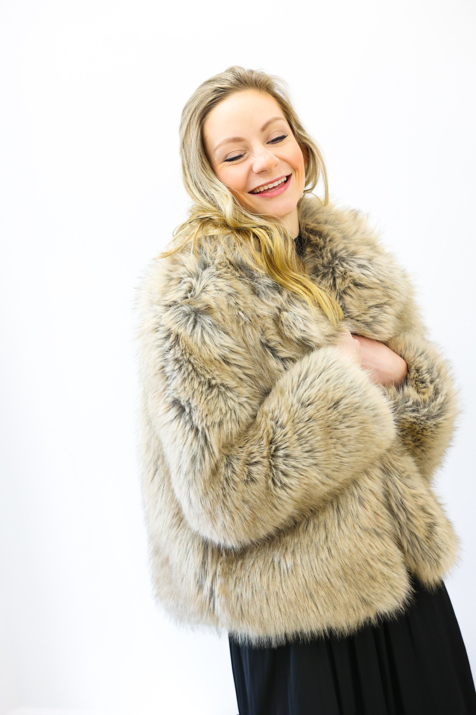 Woman wearing a fur coat on a white background
