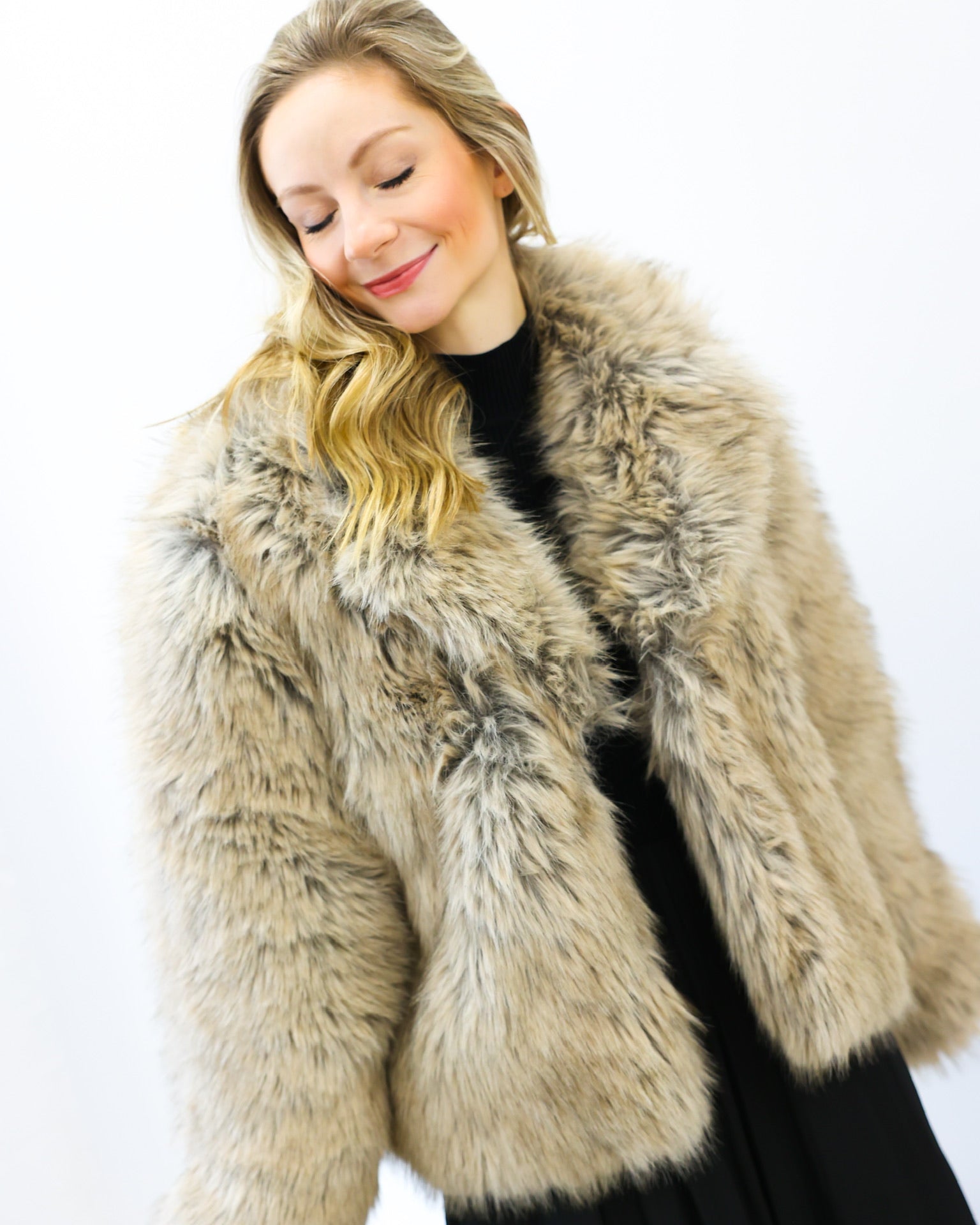 Woman wearing a fur coat against a white background