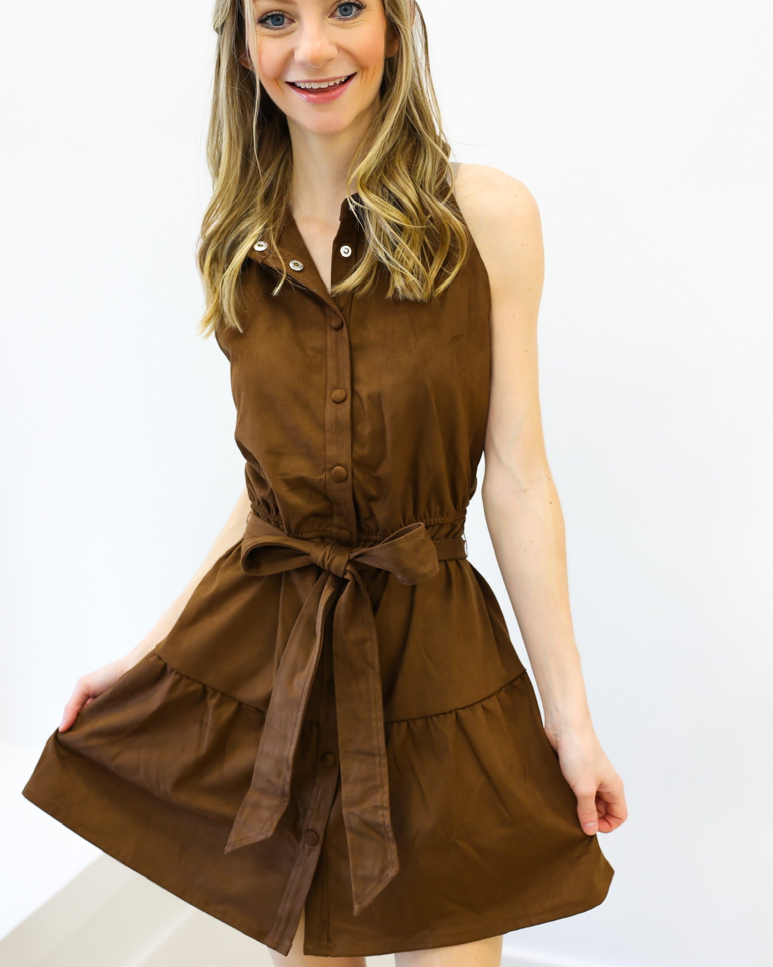 Woman wearing a brown dress with a white background