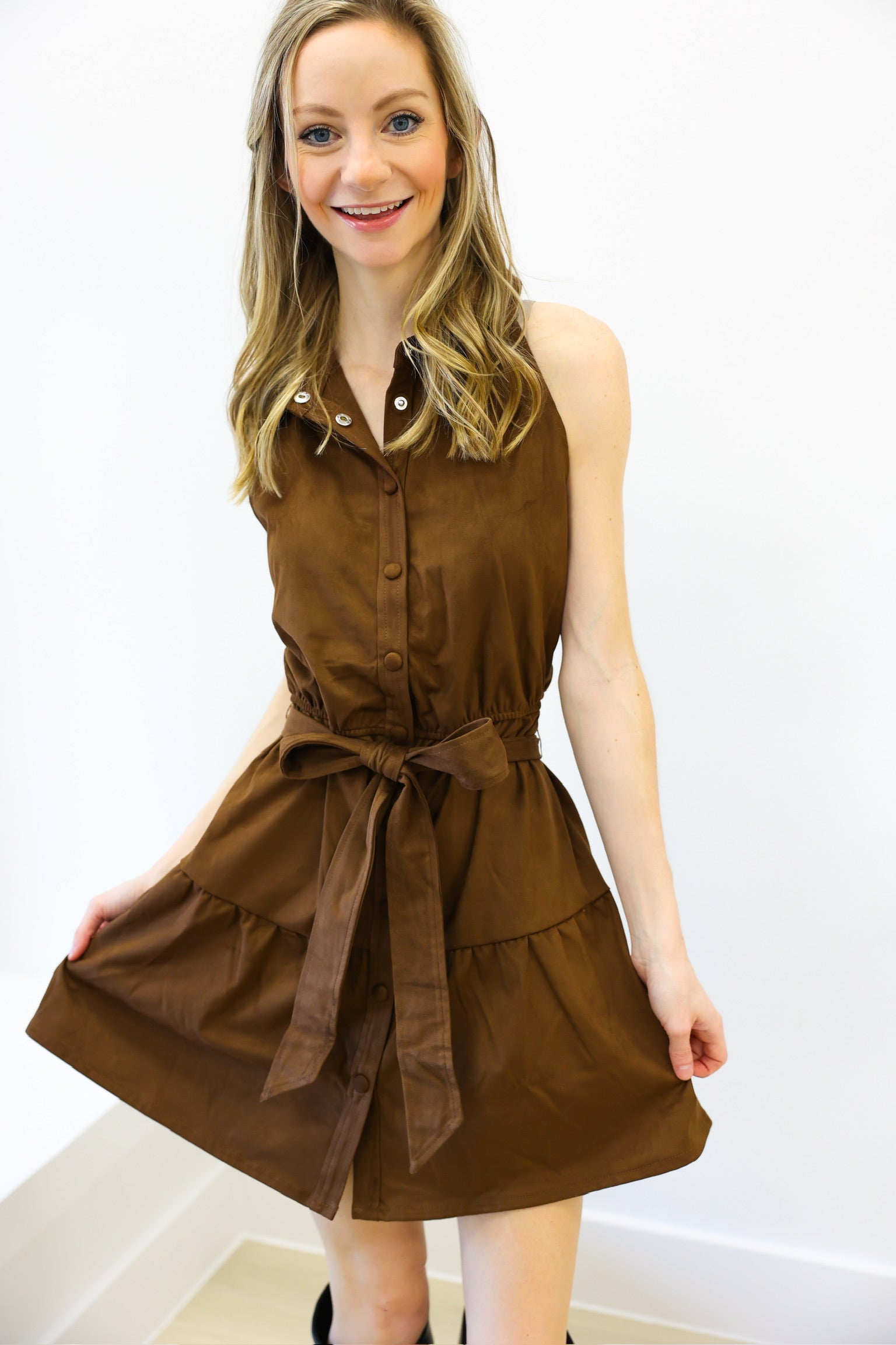 Woman wearing a brown dress with a white background