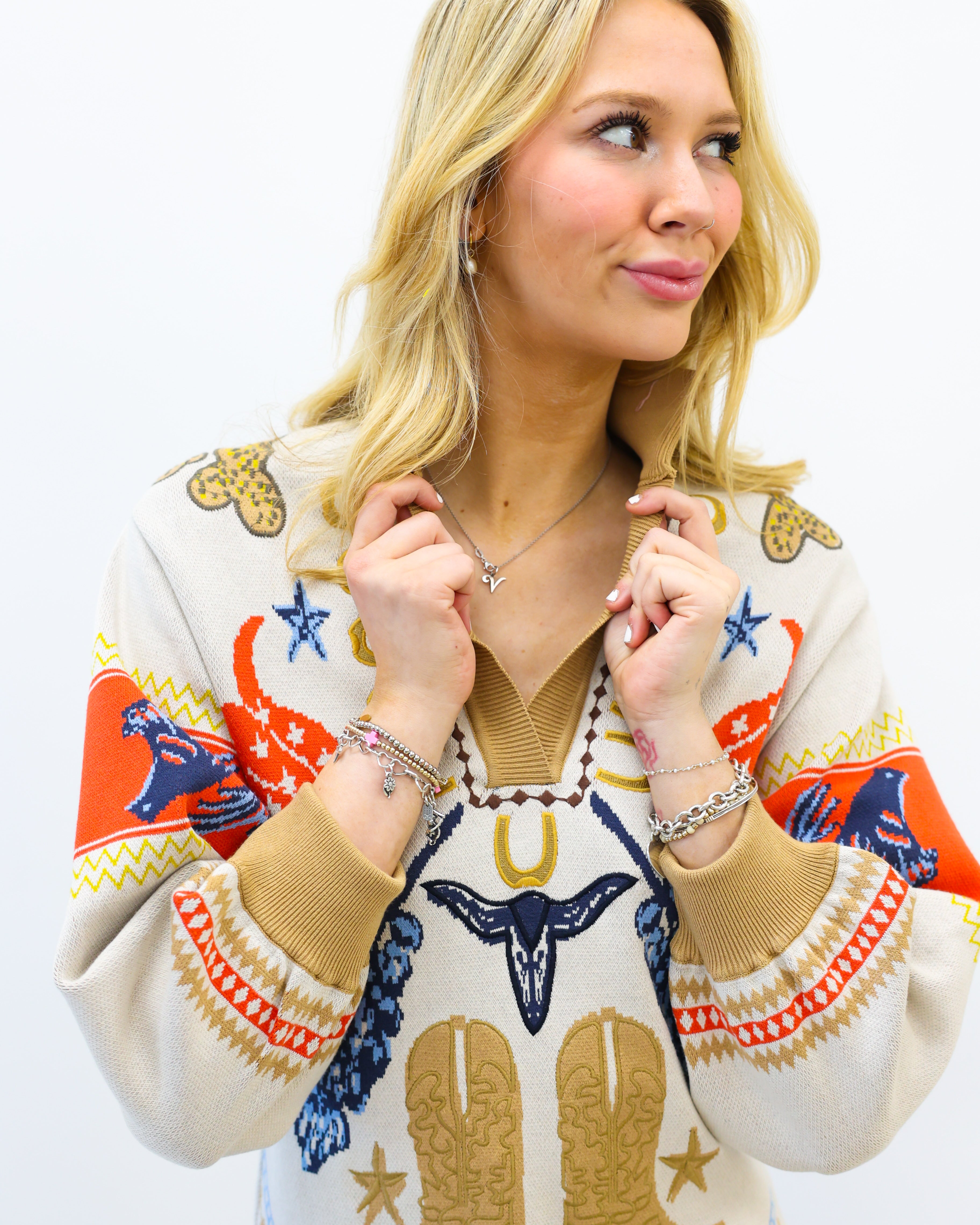 Woman wearing a colorful sweater with cowboy boot design on a white background