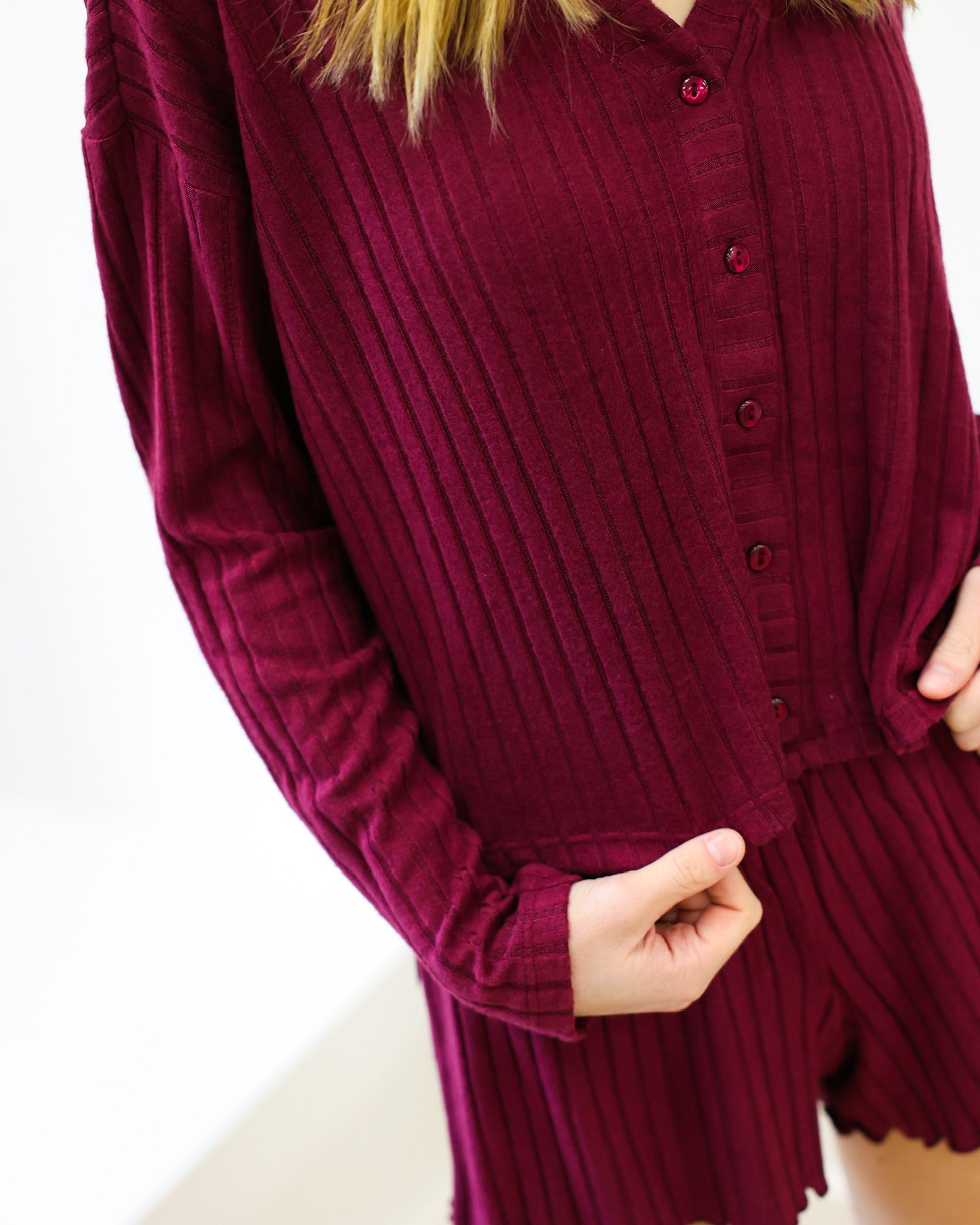 Maroon ribbed long-sleeve top and shorts set on a white background