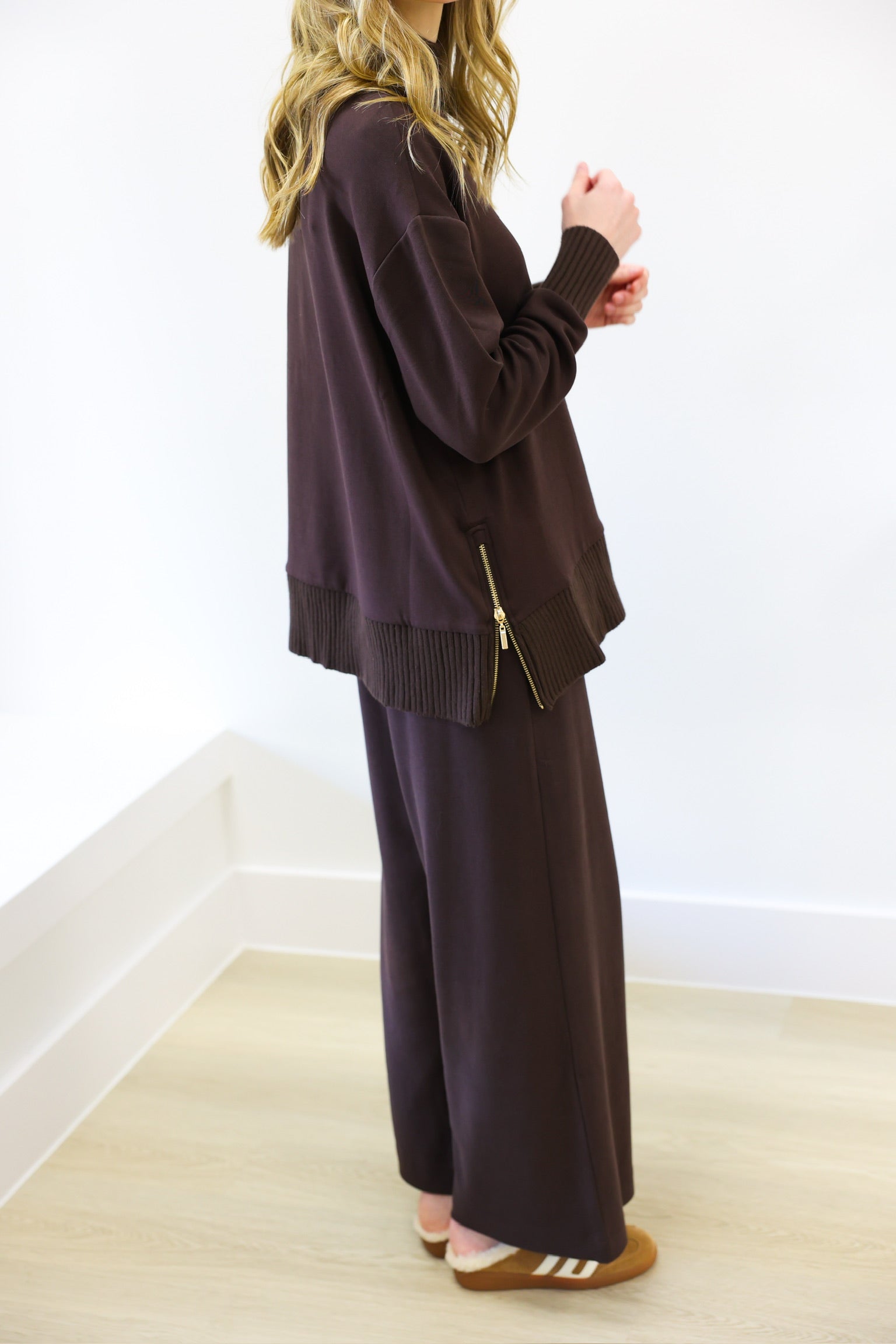 Person wearing a brown outfit with a white background