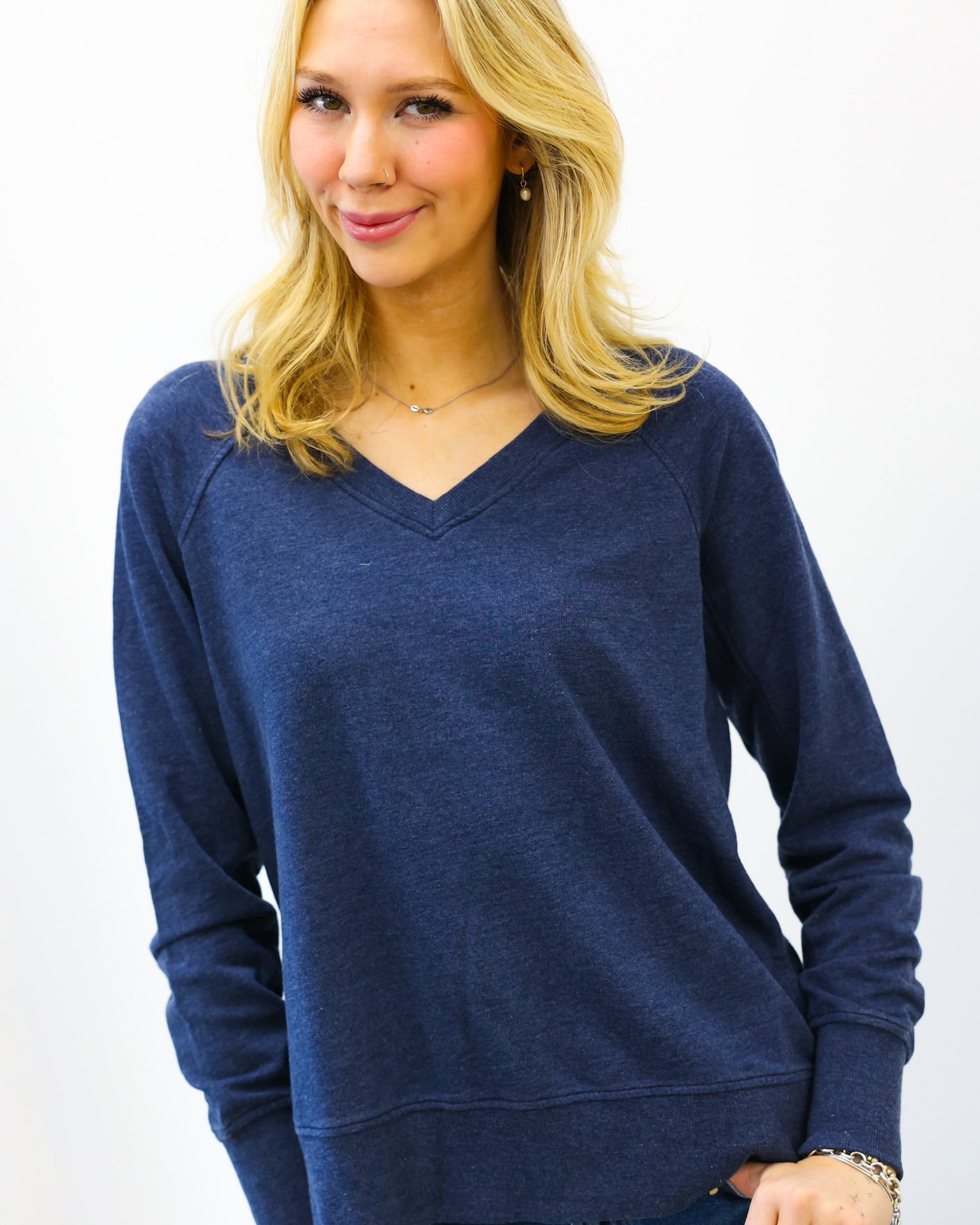 Woman wearing a blue sweater against a white background