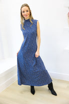 Woman wearing a blue dress with a white background