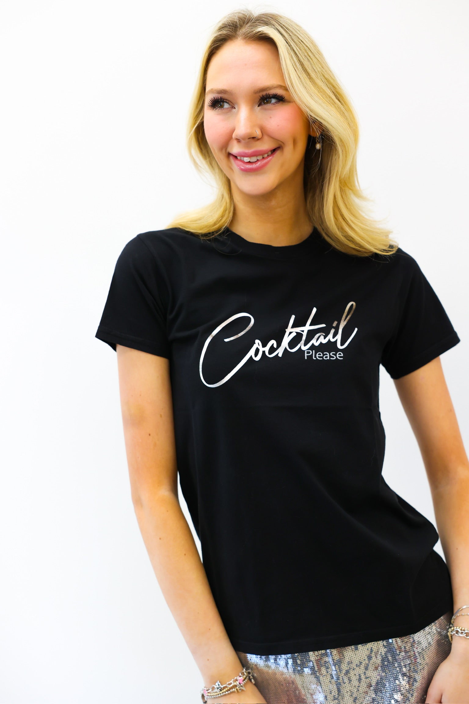 Woman wearing a black t-shirt with 'Cocktail Please' text on a white background
