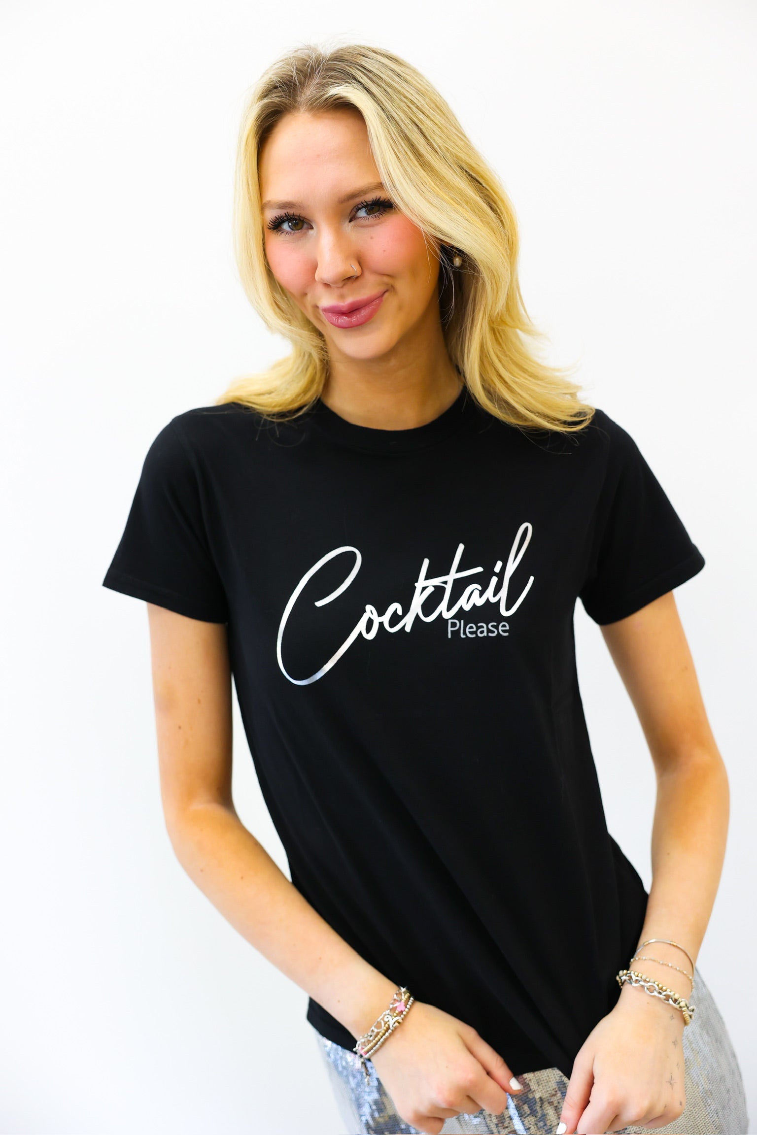 Woman wearing a black t-shirt with 'Cocktail Please' text on a white background