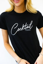 Person wearing a black t-shirt with 'Cocktail Please' text on a white background