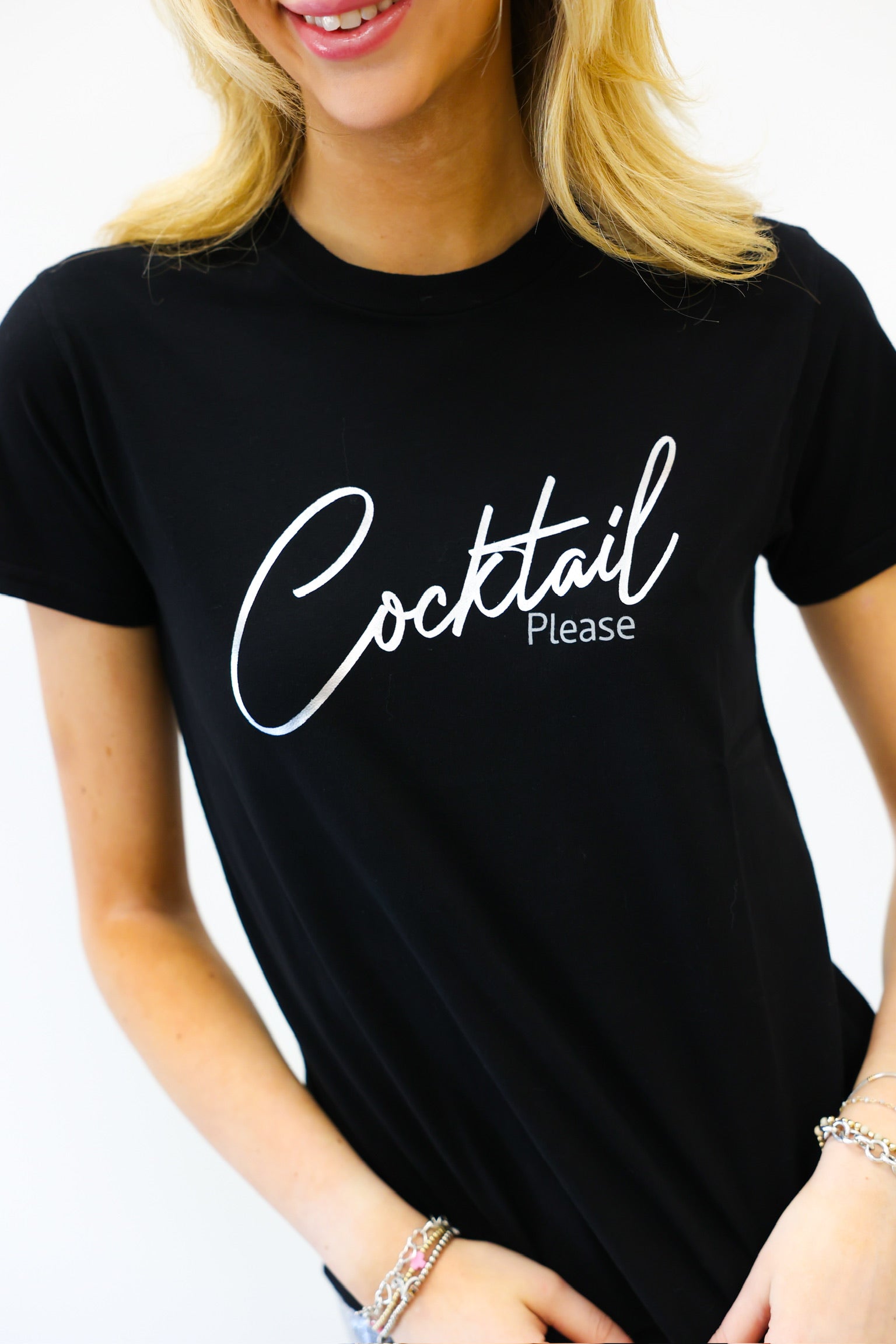 Person wearing a black t-shirt with 'Cocktail Please' text on a white background