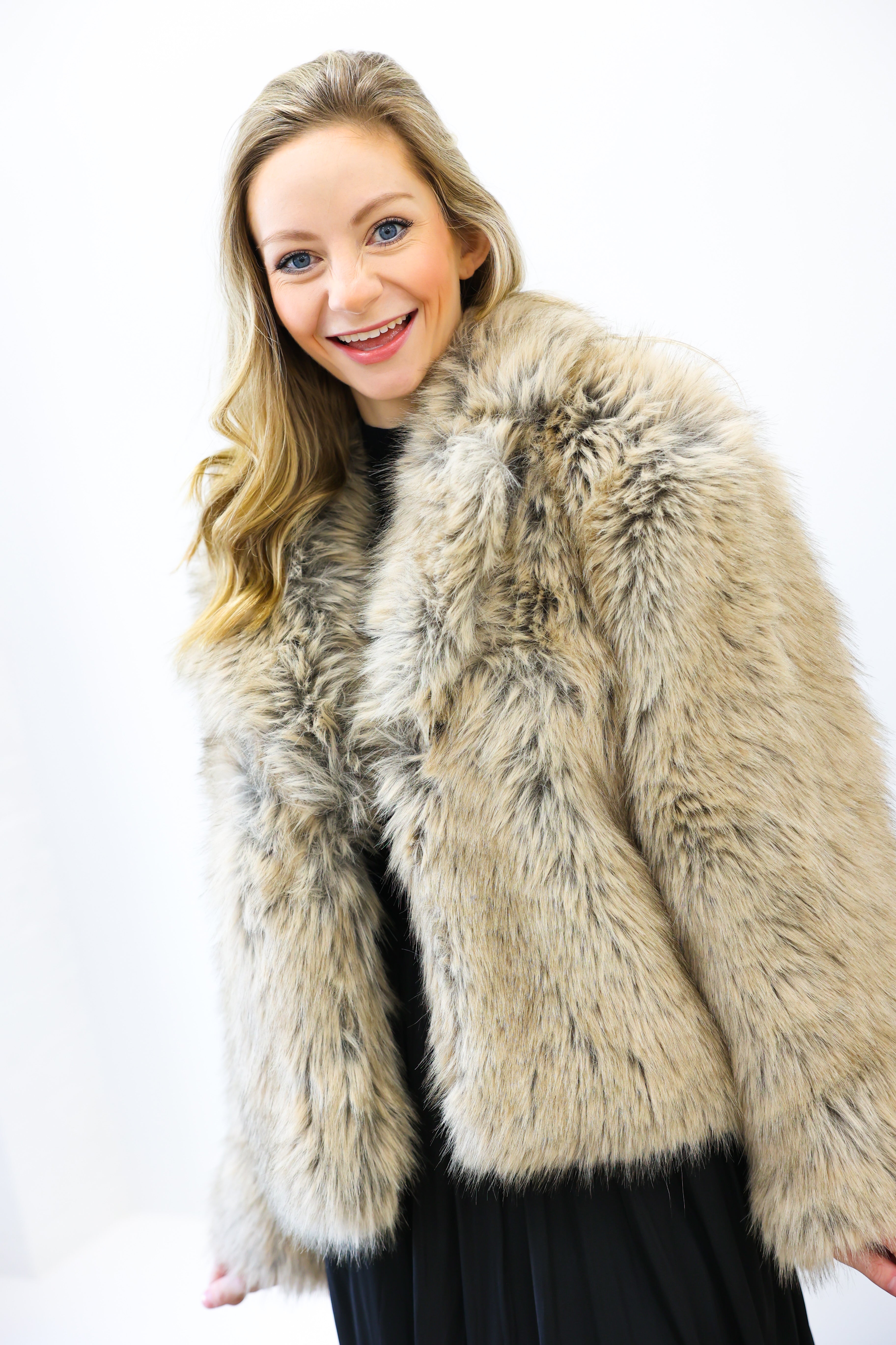 Woman wearing a fur coat against a white background