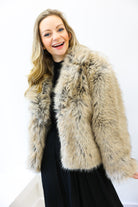 Woman wearing a fur vest against a white background