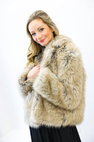 Woman wearing a fur coat against a white background