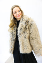 Woman wearing a fur coat against a white background