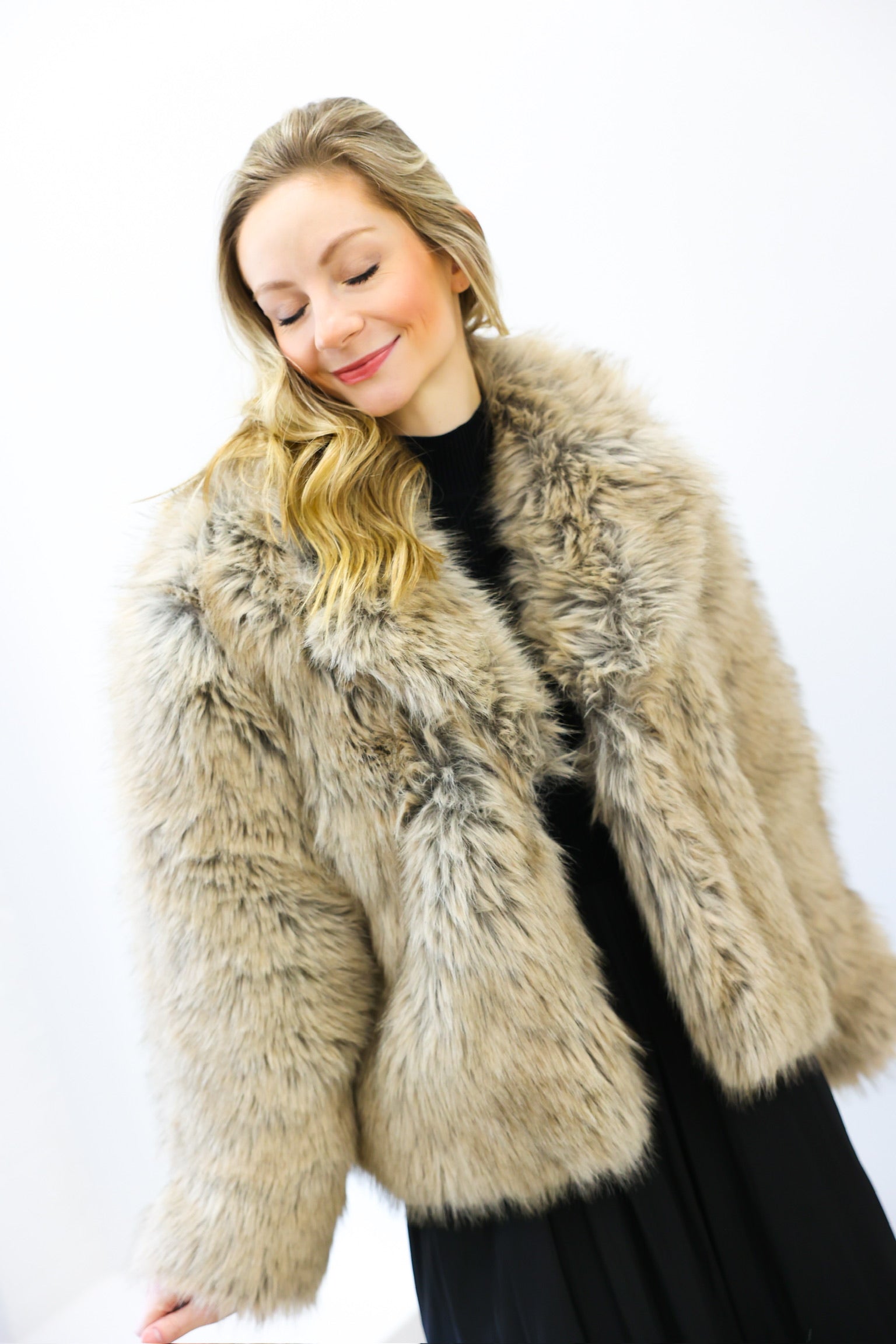 Woman wearing a fur coat against a white background