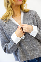 grey sweater with sequins and white collar detail