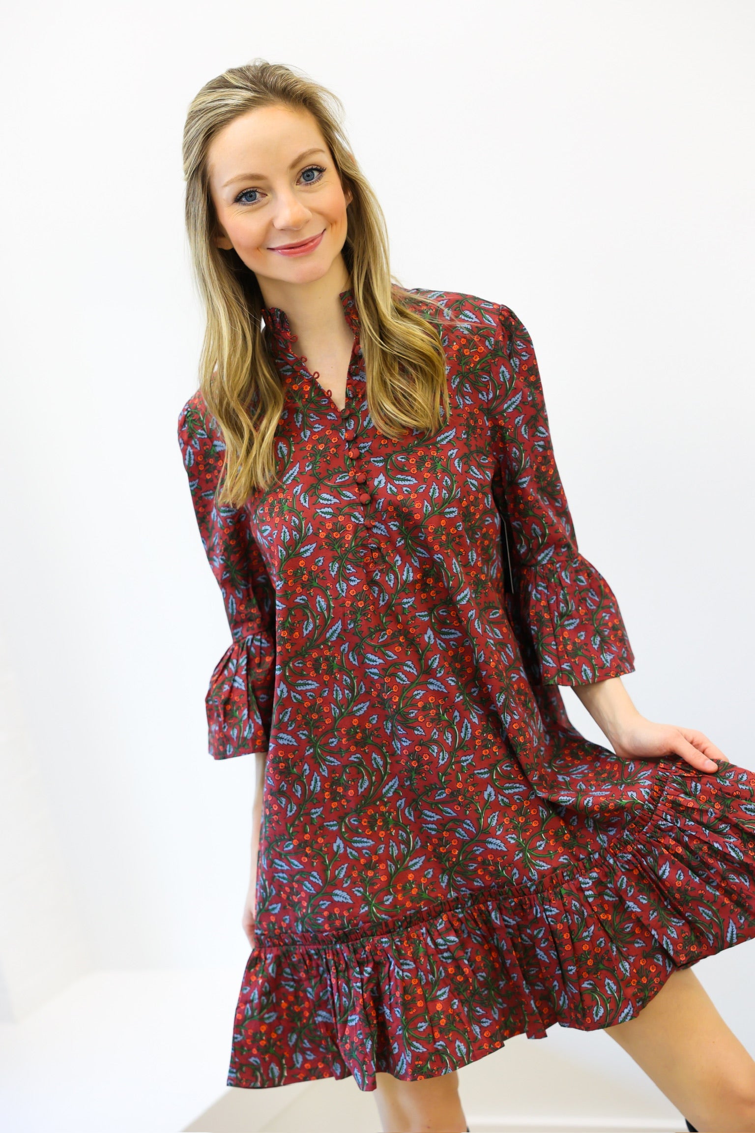 Woman wearing a patterned dress on a white background