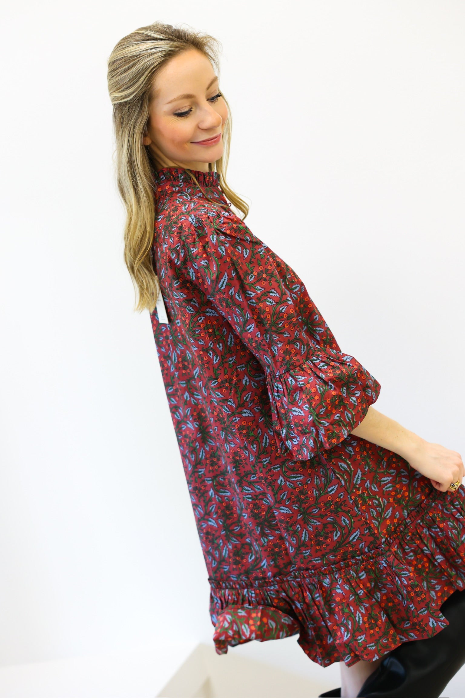 Woman wearing a red floral dress on a white background