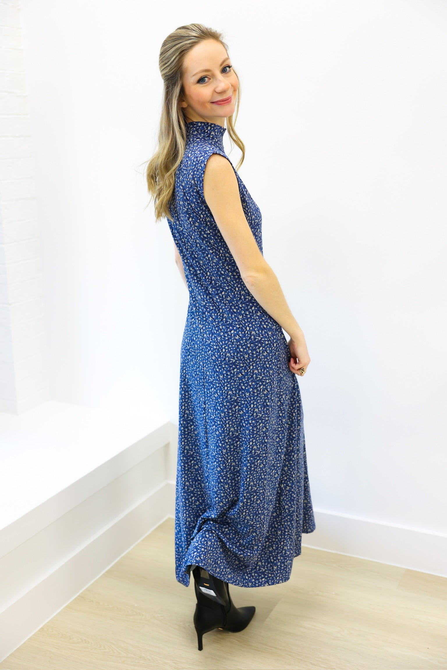 Woman wearing a blue dress with a white background