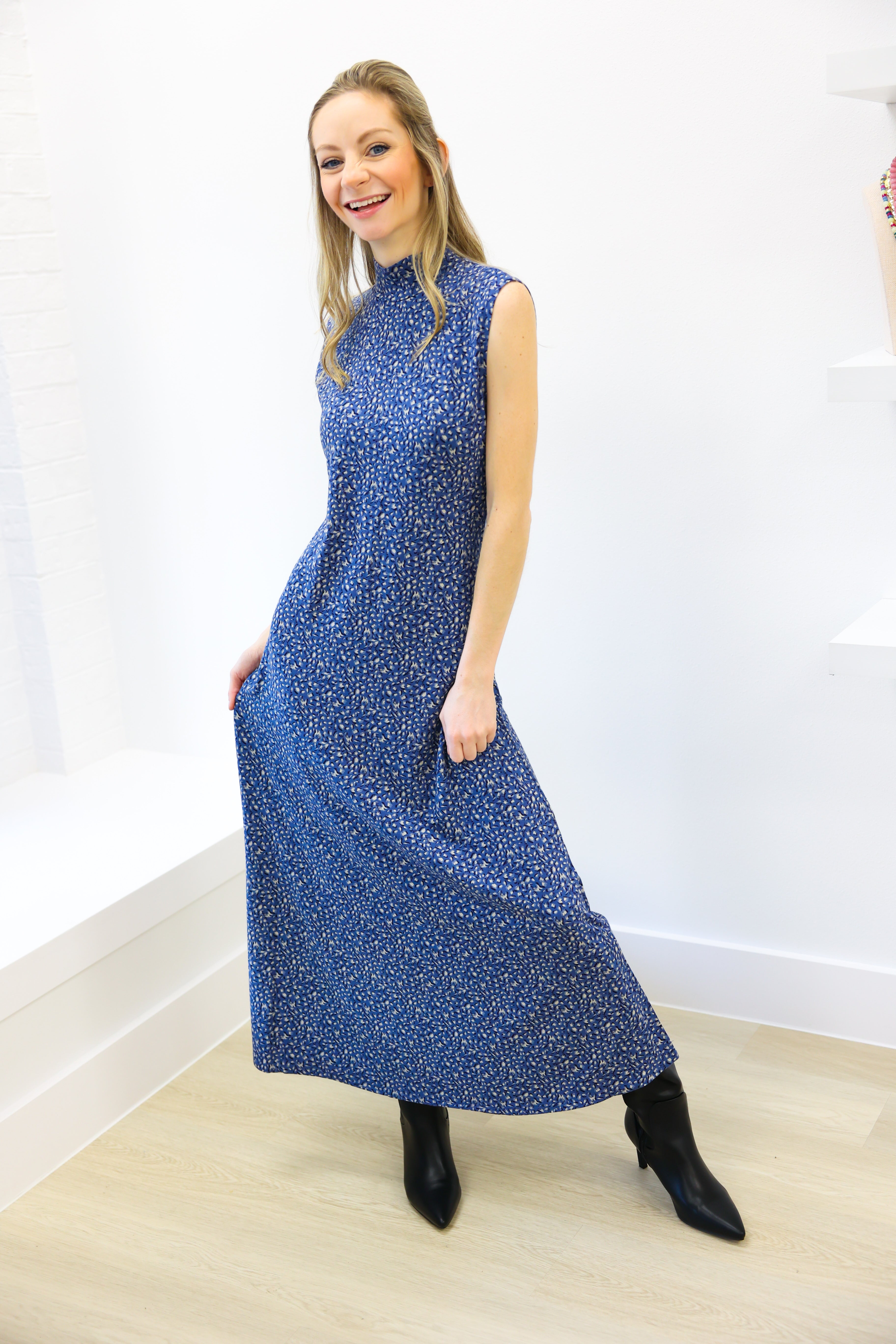 Woman wearing a blue dress with a white background