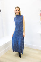 Woman wearing a blue dress with a white background
