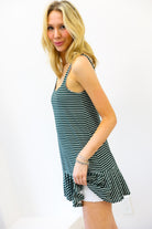 Woman wearing a striped dress with a white background