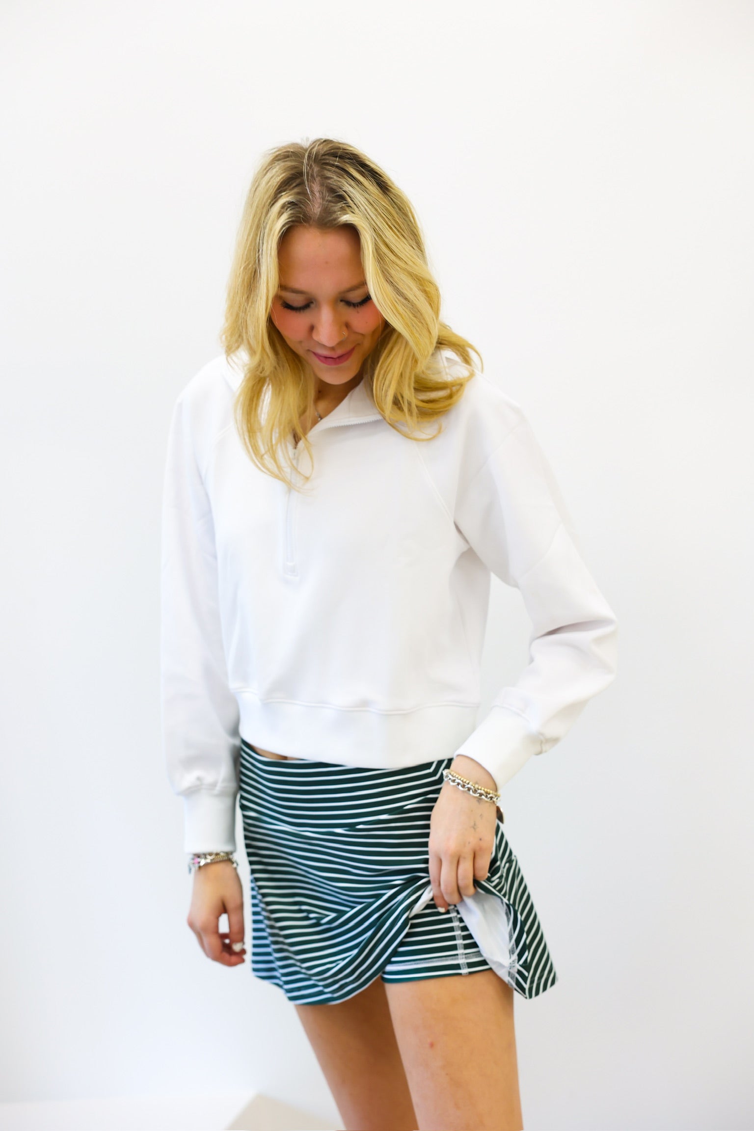 Woman wearing a white blouse and striped skirt on a white background