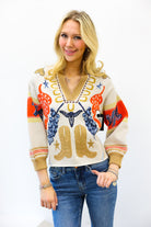 Woman wearing a colorful sweater with cowboy boot design on a white background