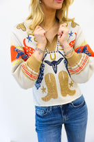 Woman wearing a colorful sweater with cowboy boot designs on a white background
