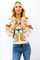 Woman wearing a patterned sweater with cowboy boots and stars design on a white background