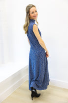 Woman wearing a blue dress with a white background