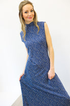Woman wearing a blue dress with a white background