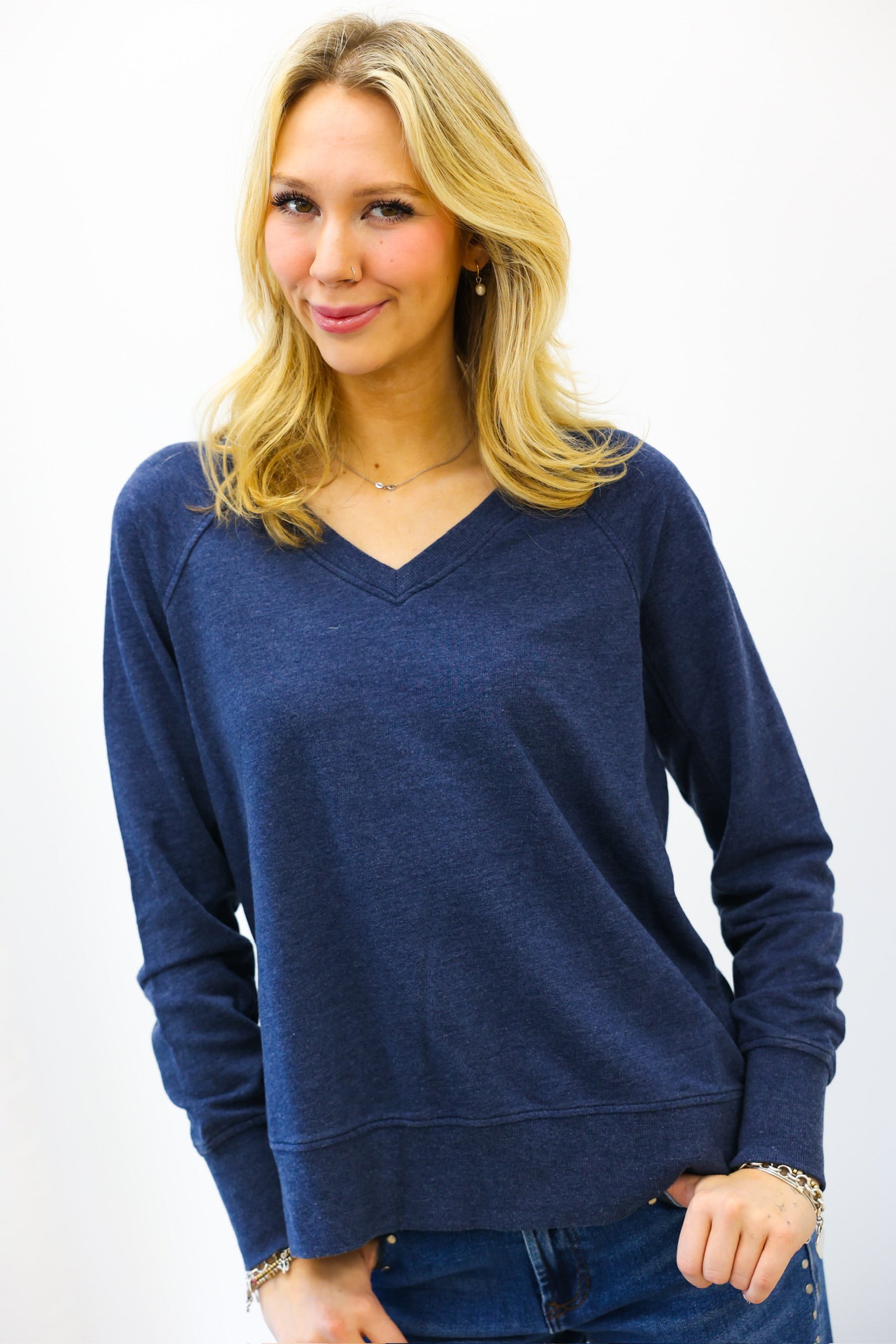 Woman wearing a blue sweater against a white background